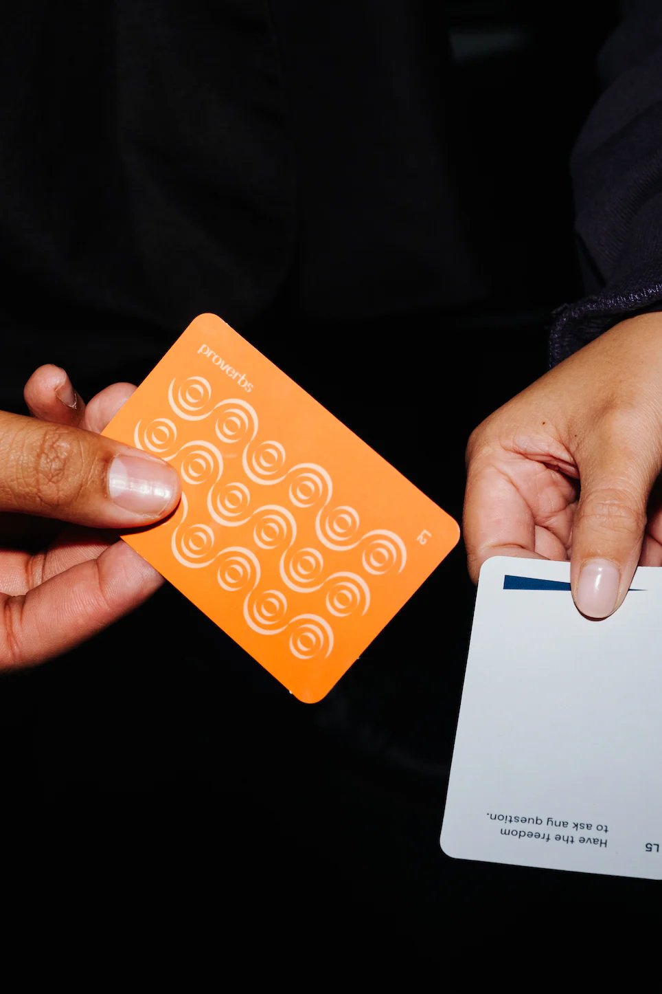 Hand holding an orange Lalaga conversation card