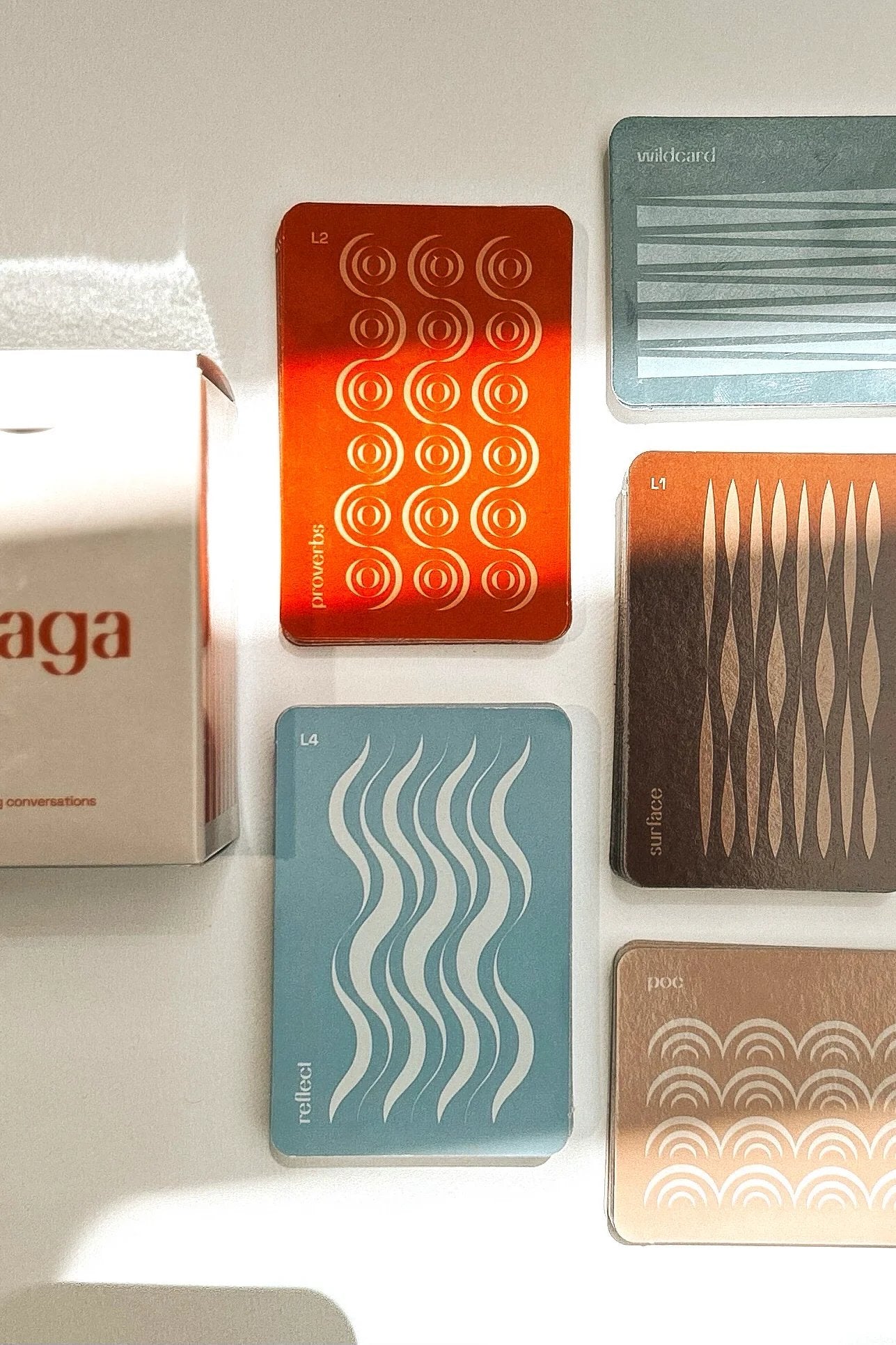 Lalaga card game box with colourful card decks spread out